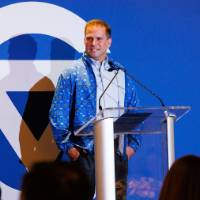 An alum speaker give welcome remarks